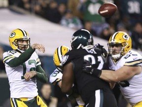 Aaron Rodgers of the Green Bay Packers passes the ball against Fletcher Cox of the Philadelphia Eagles in the fourth quarter at Lincoln Financial Field on Monday in Philadelphia.