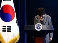 South Korean President Park Geun-Hye bows during an address to the nation, at the presidential Blue House in Seoul on November 29, 2016. South Korea's scandal-hit President Park Geun-Hye said Tuesday she was willing to stand down early and would let parliament decide on her fate.