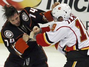 Joseph Cramarossa, left, of the Anaheim Ducks tangles with Matthew Tkachuk of the Calgary Flames during NHL action Sunday in Anaheim. The Ducks won 4-1 to make it 26 straight wins over Calgary on home ice.