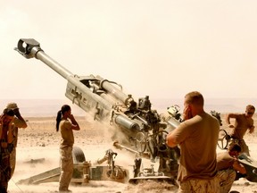 A Canadian artillery unit fires a 155-millimetre Howitzer shell against an insurgent position in Helmand Province, Afghanistan in July 2006.