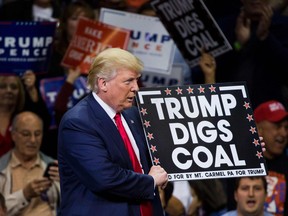 Republican presidential nominee Donald Trump  holds a sign supporting coal during a rally at Mohegan Sun Arena in Wilkes-Barre, Pennsylvania on October 10, 2016