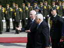 Palestinian President Mahmoud Abbas (2ndR) and Canada's Governor General David Johnston (L) walk on the red carpet during a welcome ceremony on November 4, 2016 before a meeting in the West Bank city of Ramallah.