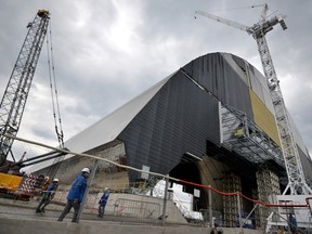 A picture taken on April 22, 2016 shows Chornobyl's New Safe Confinement (R).