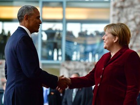 Obama shakes hands with German Chancellor Angela Merkel upon arrival at the chancellery on November 17, 2016 in Berlin