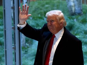 President-elect  Donald Trump waves after a meeting at the New York Times on November 22, 2016 in New York