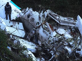 Rescue teams work in the recovery the bodies of victims of the LAMIA airlines charter that crashed in the mountains of Cerro Gordo, municipality of La Union, Colombia, on November 29, 2016