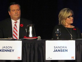 Progressive Conservative candidates Jason Kenney, a former Conservative MP, and Sandra Jansen sit next to each other during the Alberta Progressive Conservative party leadership forum in Red Deer, Alta. on Saturday, Nov. 5, 2016.