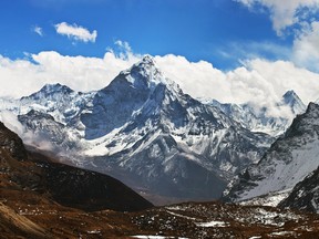 Snow and ice rolling down Mount Ama Dablam killed a Sherpa guide and injured a British climber on Monday.