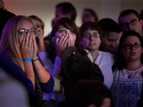 People react to the announcement that Republican presidential candidate Donald Trump has carried another state, while gathering at a Democratic election night party at Sheraton Hotel in Salt Lake City on Tuesday, Nov. 8, 2016.