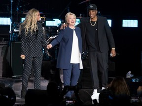 Jay Z, right, and Beyonce, left, stand with Democratic presidential candidate Hillary Clinton during a campaign rally in Cleveland, Friday, Nov. 4, 2016.