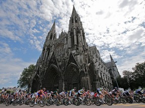 In a July 5, 2012 file photo, the pack passes a church in Rouen during the start of the fifth stage of the Tour de France.