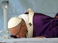 Pope Francis kisses the altar as he celebrates a Mass on the occasion of All Souls' Day, at the Prima Porta Cemetery in Rome, Wednesday, Nov. 2, 2016.