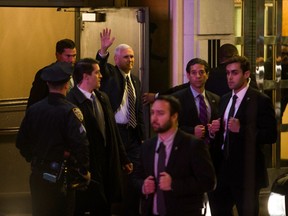 Vice President-elect Mike Pence, top center, leaves the Richard Rodgers Theatre after a performance of "Hamilton," in New York, Friday, Nov. 18, 2016.