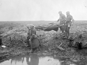 Canadians wounded in the  Battle of Passchendaele are taken to an aid-post in November 1917.