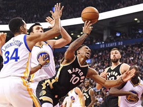 Toronto Raptors guard DeMar DeRozan is fouled by Golden State Warriors centre Zaza Pachulia (back) during an NBA game in Toronto on Wednesday, Nov. 16, 2016.