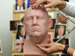 Principal Sculptor David Gardner measures an unfinished wax figure of President-elect Donald Trump, which will be released in January, at the Madame Tussauds studio in west London.