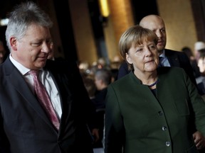 German Chancellor Angela Merkel,right, and the President of the German Federal Intelligence Agency (BND) Bruno Kahl attend a ceremony for the 60th anniversary of the founding of the BND in Berlin, Germany, Monday Nov. 28, 2016.