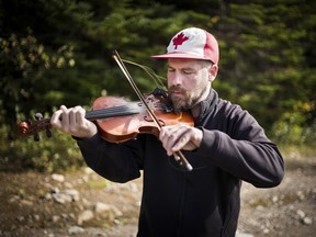 Ashley MacIsaac, a virtuoso of of traditional Cape Breton fiddling, demonstrates his seemingly effortless style during the isolated island's annual music festival, in Canada.