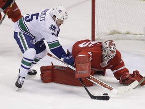 Derek Dorsett of the Vancouver Canucks is stopped on a scoring attempt by Red Wings goalie Jimmy Howard during the third period of their game Thursday night in Detroit.