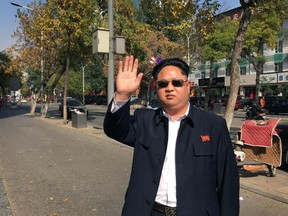 Kim Jong Un impersonator Jia Yongtang in costume complete with navy blue Mao suit, on the street in Taiyuan, the capital of coal-producing Shanxi province.