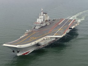 In this May 2012 file photo provided by China's Xinhua News Agency, Chinese aircraft carrier Liaoning cruises for a test in the sea