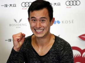 Patrick Chan of Canada celebrates after winning the men's gold medal at the Cup of China Grand Prix event on Saturday at the Capital Gymnasium in Beijing.