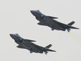 A pair of J-20 stealth fighter jets fly at the China's International Aviation and Aerospace Exhibition in Zhuhai, China's Guangdong province, Tuesday, Nov. 1, 2016.