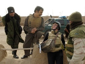 Christie Blatchford shares a lighter moment with some Afghan soldiers on one of her tours of Afghanistan.