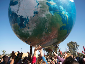 Delegates play with a giant globe outside the climate conference in Morocco on Friday.