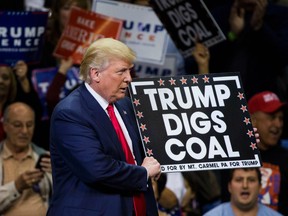 Republican presidential nominee Donald Trump  holds a sign supporting coal during a rally at Mohegan Sun Arena in Wilkes-Barre, Pennsylvania on October 10, 2016. / AFP PHOTO / DOMINICK REUTERDOMINICK REUTER/AFP/Getty Images