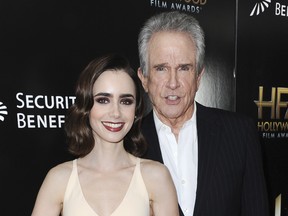 Lily Collins, left, and Warren Beatty attend the press room at the 2016 Hollywood Film Awards held at the Beverly Hilton on Sunday, Nov. 6, 2016, in Beverly Hills, Calif.