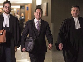 Former Montreal mayor Michael Applebaum, flanked by his lawyers, is on trial for fraud and breach of trust. The judge is hearing closing arguments from the defence.