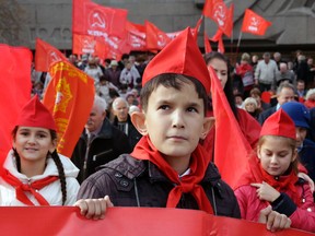 Youngsters equipped with red flags take part in a rally to mark the 99th anniversary of Russia's Bolshevik Revolution in Sevastopol, Crimea