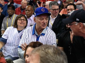 Karen Michael (left) sits with Bill Murray (centre) at the Chicago Cubs' World Series game in Cleveland on Nov. 1.