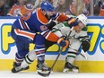 Edmonton Oilers' Eric Gryba, left, rides Dallas Stars' Radek Faksa hard into the boards during NHL action Friday night in Edmonton. The Stars had the last laugh with a 3-2 victory.