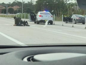 A photo taken by a motorist shows an altercation on a Florida interstate involving Deputy Sheriff Dean Bardes.