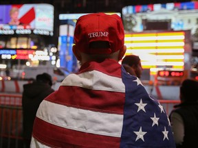A Donald Trump supporter watches the screens outside Times Square Studios as he awaits the results of the U.S. presidential election on Nov. 9, 2016 in New York City.
