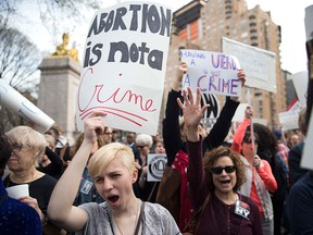 New Yorkers rally to condemn Donald Trump's remarks about women and abortion on March 31, 2016.