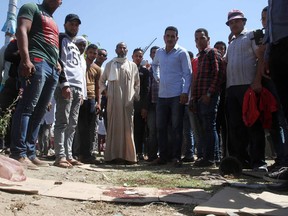 Egyptians gather at the site where a policeman shot and killed a street vendor on April 19, 2016, on the eastern outskirts of the capital Cairo.