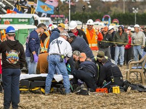 Paramedics tend to a woman who was critically injured after an apparatus used to launch pumpkins exploded at the World Championship Punkin Chunkin Contest in Bridgeville, Delaware.