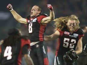 Ottawa Redblacks wide receiver Jake Harty (8) and linebacker Tanner Doll (52) celebrate their victory on Nov. 27.