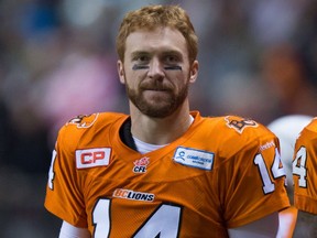 In this Oct. 23, 2015 file photo, B.C. Lions quarterback Travis Lulay watches from the sideline during a game against the Hamilton Tiger-Cats.