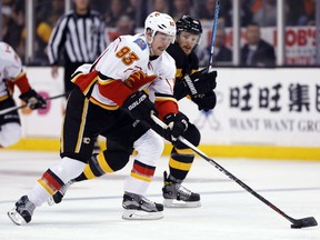 Calgary Flames forward Sam Bennett, left, breaks away from Boston Bruins defenceman Kevan Miller en route to a goal during the Flames' 2-1 win Friday at TD Garden in Boston.