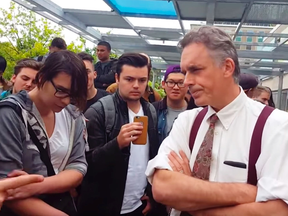 Professor Jordan Peterson, right, speaks with protestors at a rally in Toronto.