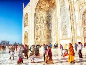 Many tourists take in the Taj Mahal in Agra in a rushed day trip from Delhi, India.