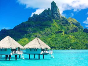 Bora Bora is set in a lagoon and surrounded by a string of motus, or small islets, where luxury resorts are located.