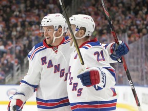 Michael Grabner, left, and Derek Stepan of the New York Rangers react after one of two goals on the night by Grabner in a 3-1 victory over the Edmonton Oilers in NHL action Sunday night in Edmonton.
