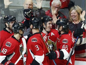 Ottawa Senators' Kyle Turris (7) celebrates his goal against the Carolina Hurricanes, with teammates Erik Karlsson (65), Marc Methot (3), Ryan Dzingel (18) and Bobby Ryan (9) during third period NHL hockey action in Ottawa on Saturday.