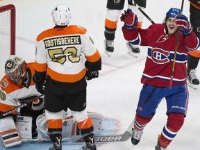 Philadelphia Flyers goaltender Michal Neuvirth and Shayne Gostisbehere react after being scored on by the Canadiens' Phillip Danault during third period NHL action in Montreal on Saturday night.