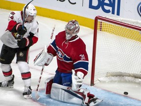 The shot by Ottawa Senators Erik Karlsson enters the net behind Montreal Canadiens goalie Carey Price as Ottawa Senators' Jean-Gabriel Pageau looks on during the third period in Montreal on Tuesday.